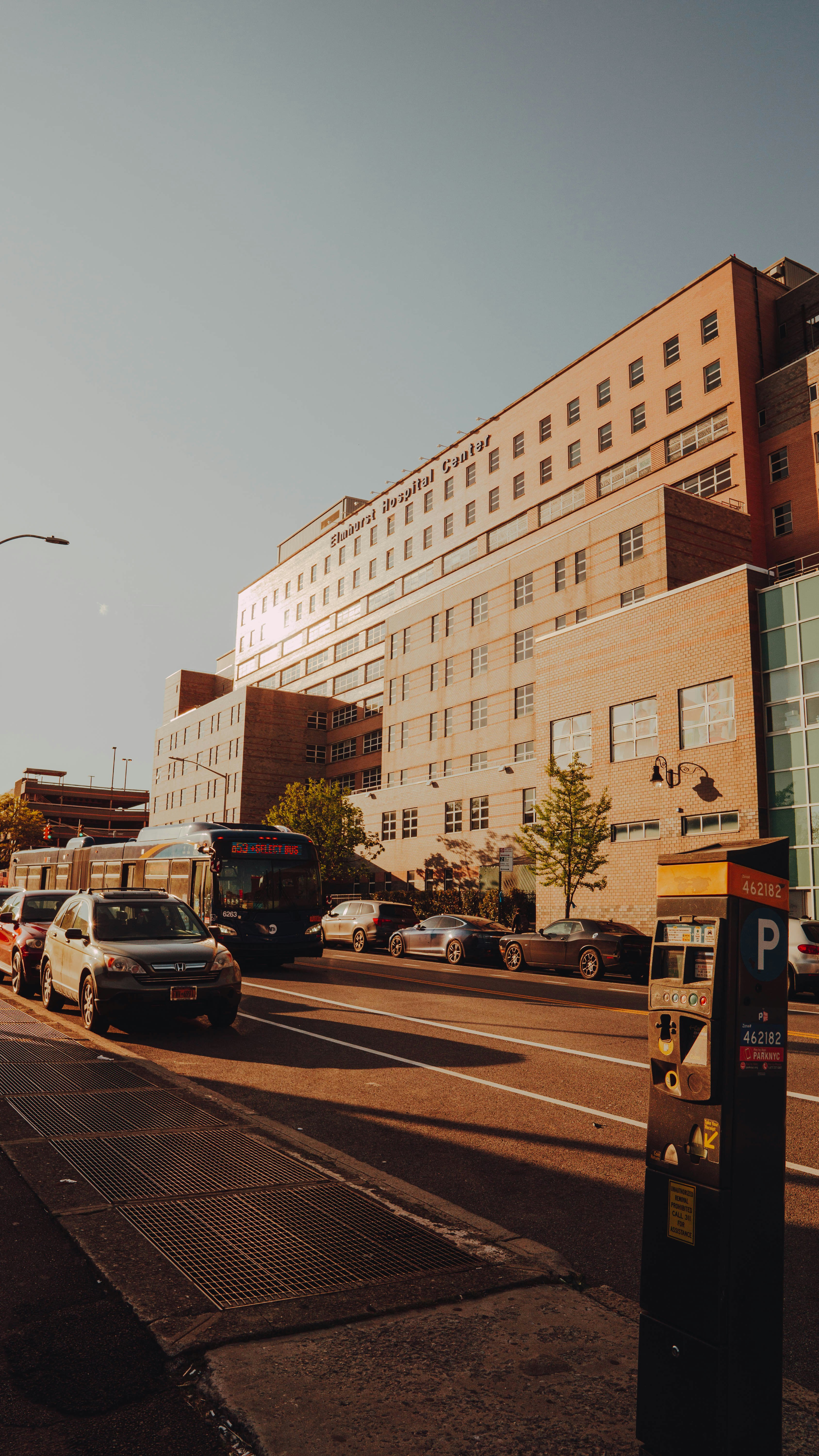 cars parked in front of brown building during daytime